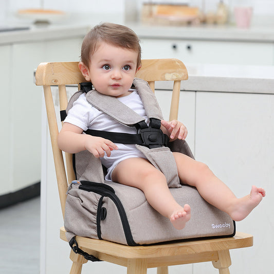 baby sits on the  Portable Baby Dining Chair