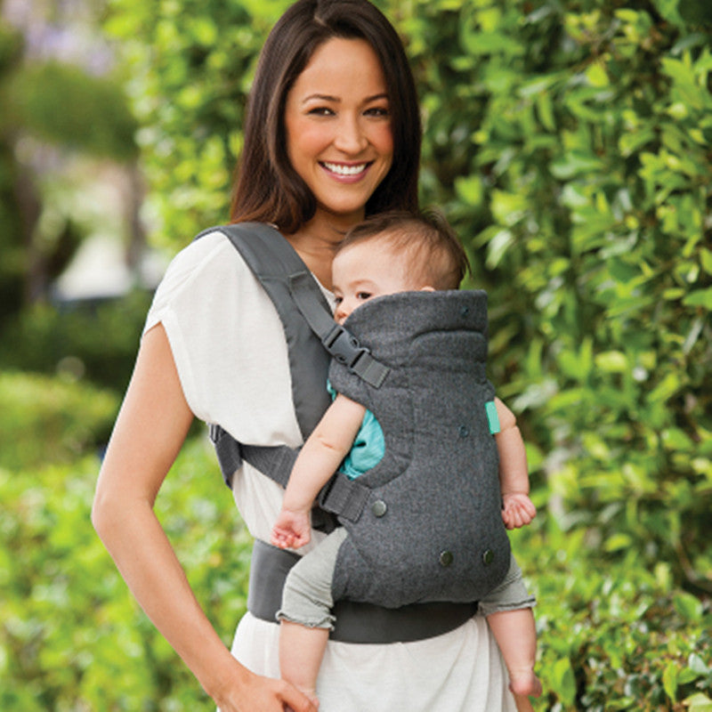 women in the nature with her baby in Baby Carrier